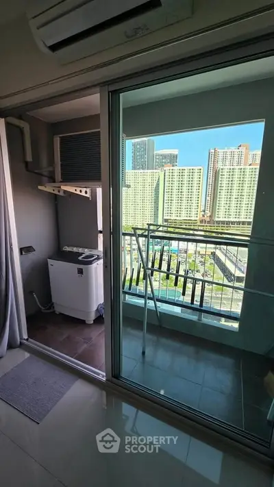 Modern apartment balcony with city view and laundry area, perfect for urban living.