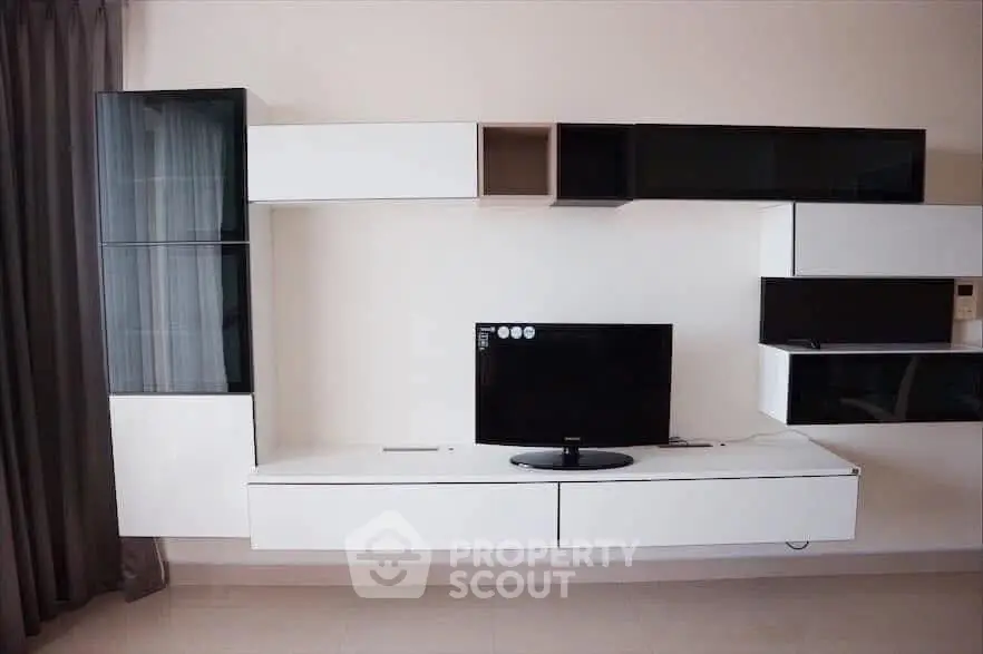 Modern living room with sleek wall-mounted TV unit and stylish storage cabinets.