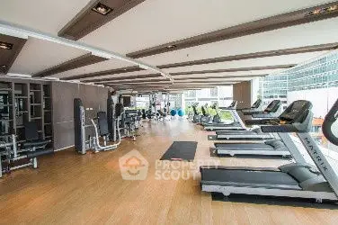 Spacious modern gym with state-of-the-art equipment and panoramic city views.