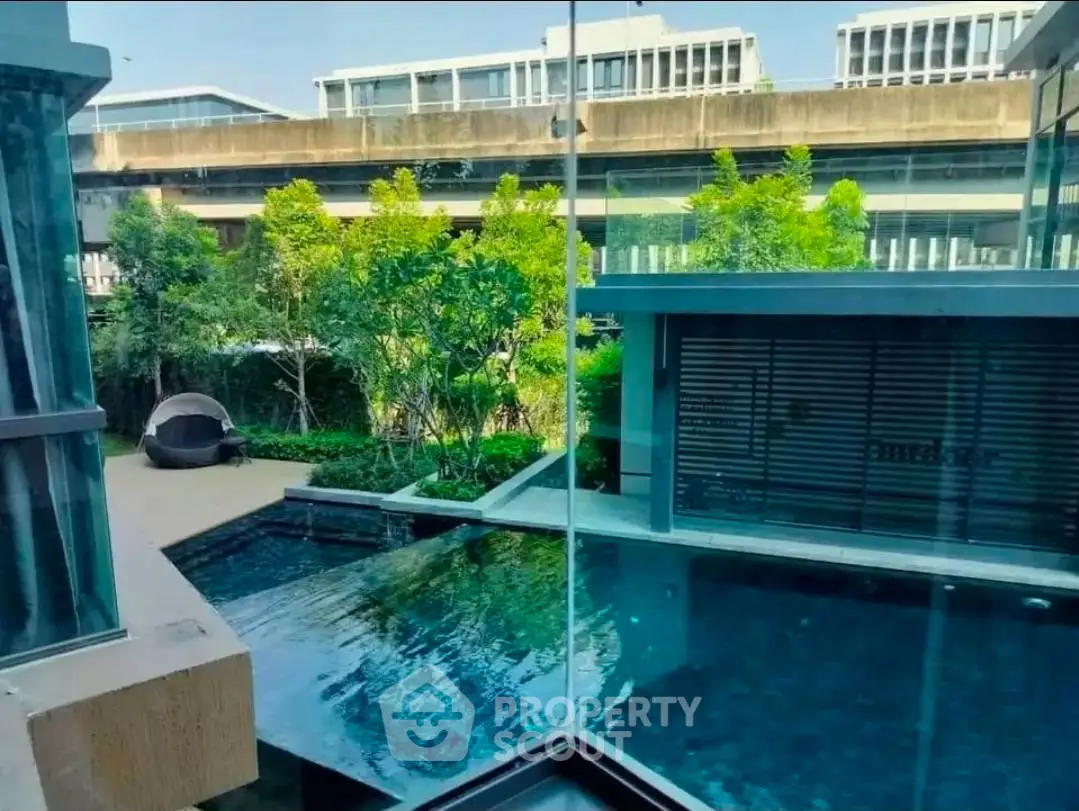 Luxurious modern pool area with lush greenery and sleek architecture, perfect for relaxation and leisure.