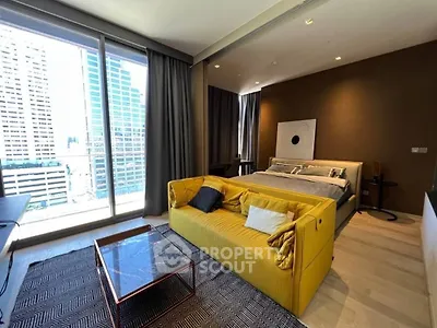 Modern bedroom with city view, featuring a stylish yellow sofa and floor-to-ceiling windows.