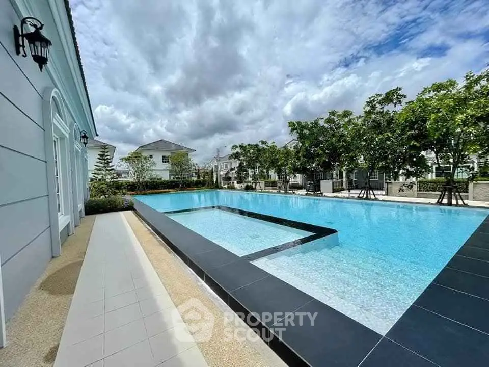 Luxurious residential pool with modern design and lush surroundings, perfect for relaxation and leisure.