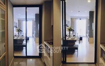 Modern open-plan living and dining area with sliding glass doors and elegant decor.