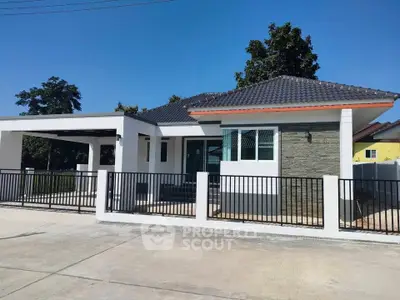 Modern single-story house with sleek design and spacious driveway