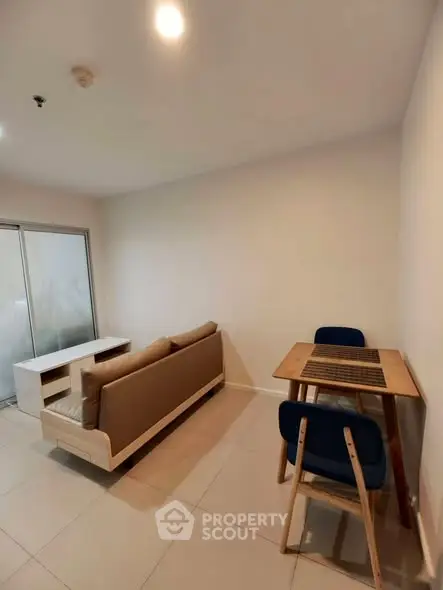 Modern living room with cozy sofa and dining table in a bright apartment