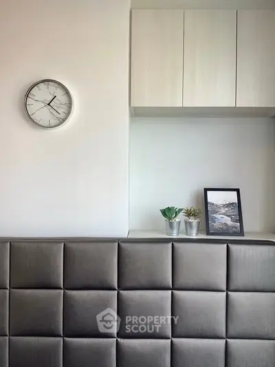 Modern minimalist interior with wall clock and decorative plants