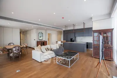 Spacious modern living room with open kitchen and elegant furnishings