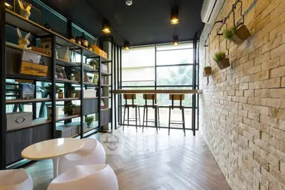 Stylish modern living room with brick accent wall and large windows