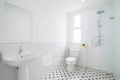 Bright and modern bathroom with sleek fixtures and stylish tile flooring.