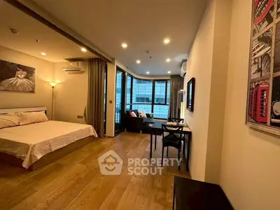 Spacious modern bedroom with wooden flooring and balcony view in urban apartment