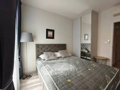 Cozy bedroom with modern decor and ample natural light