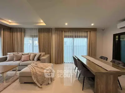 Spacious modern living room with elegant decor and ample natural light.