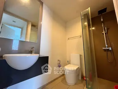 Modern bathroom with sleek fixtures and glass shower enclosure