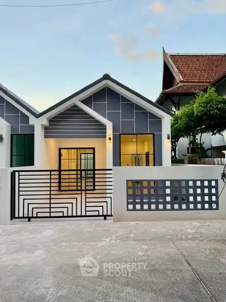 Modern single-story house with stylish facade and gated entrance