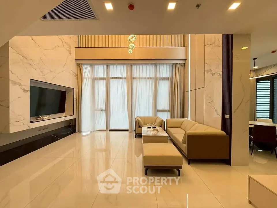 Luxurious modern living room with high ceilings, elegant marble accents, and plush seating in a sophisticated setting.