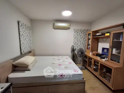 Cozy bedroom with wooden furniture and air conditioning, perfect for restful nights.