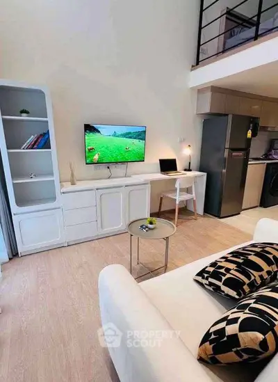 Modern living room with loft, sleek furniture, and open kitchen in stylish apartment.