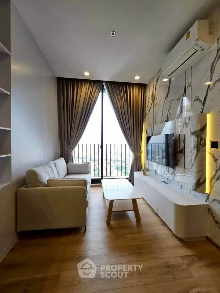 Modern living room with elegant marble wall, cozy sofa, and large window with city view.