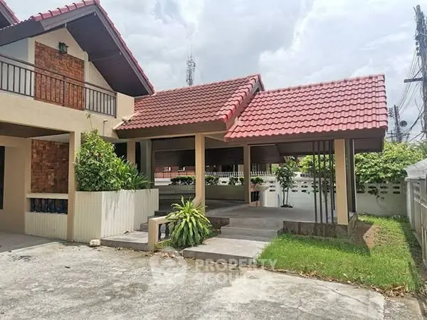 Charming suburban home with red-tiled roof and lush greenery