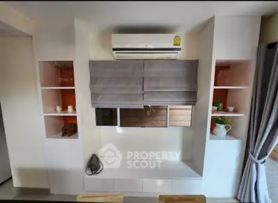 Modern living room with built-in shelves and air conditioning unit