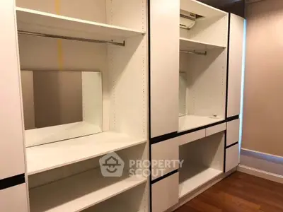 Spacious walk-in closet with modern shelving and ample storage space.
