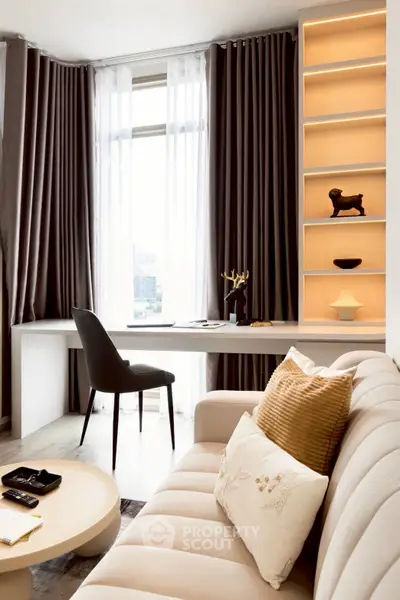Elegant living room with modern decor, featuring a cozy sofa, stylish chair, and built-in shelving.