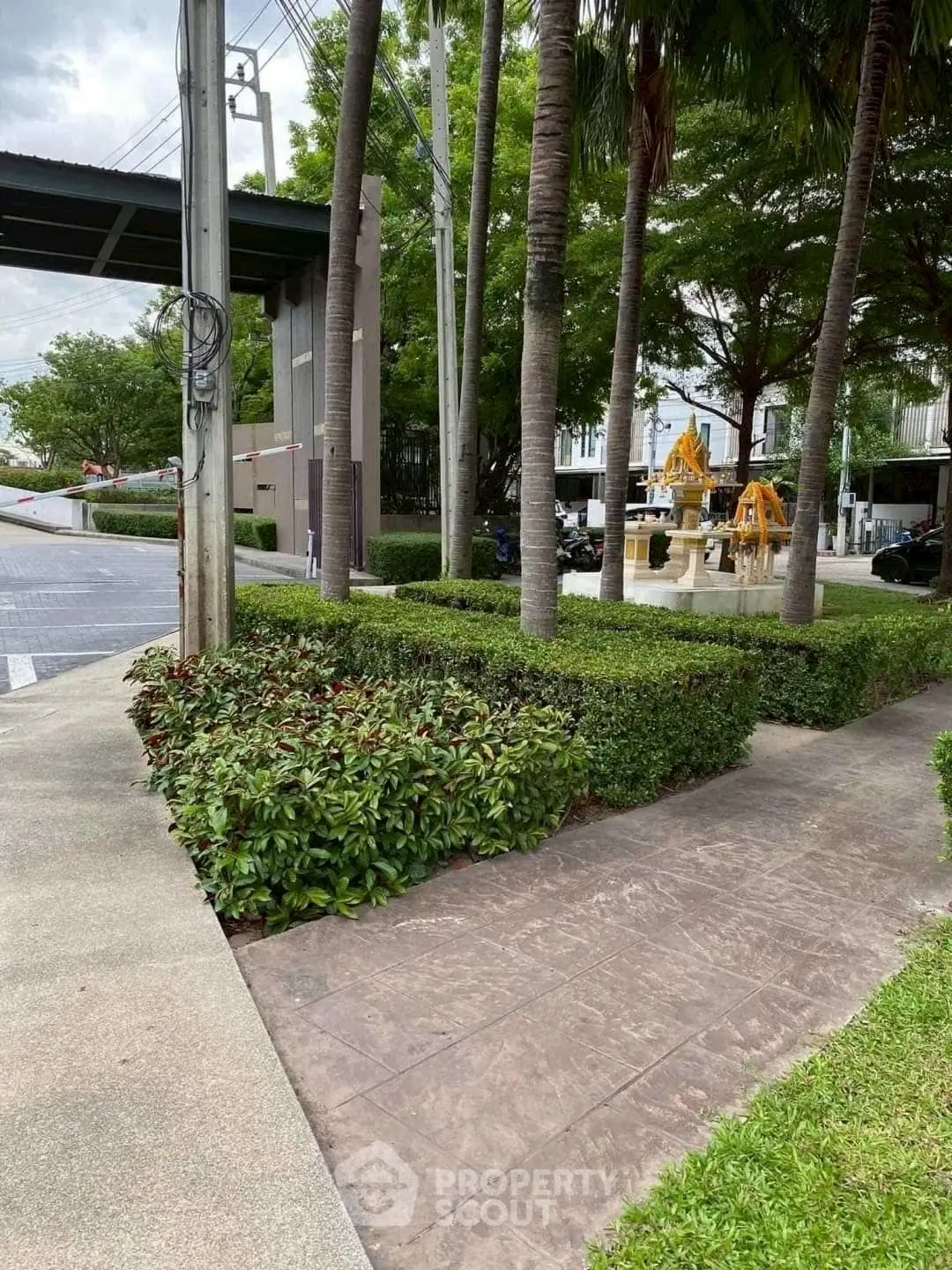 Beautifully landscaped garden area with lush greenery and trees in a modern residential complex.