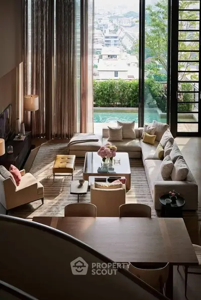Luxurious living room with floor-to-ceiling windows and stunning city view, featuring elegant furniture and decor.
