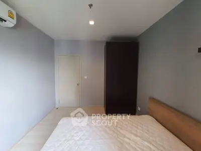 Spacious bedroom with minimalist design and ample natural light