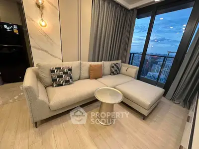 Modern living room with stylish sofa and city view from balcony.