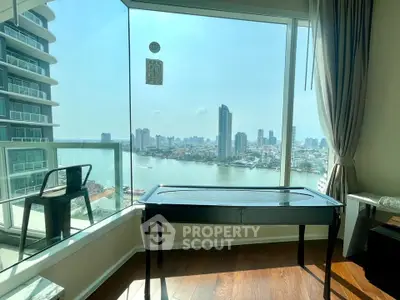 Stunning river view from modern high-rise apartment with floor-to-ceiling windows and elegant decor.