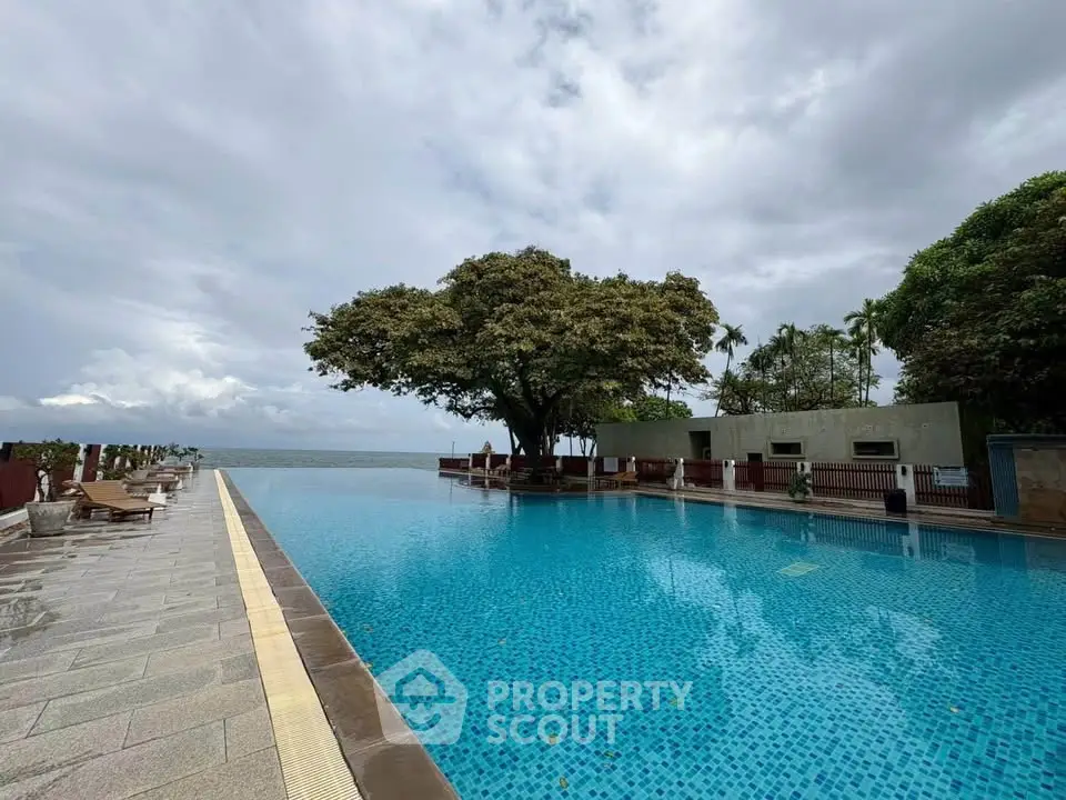 Luxurious infinity pool with stunning ocean view and lush greenery, perfect for relaxation and leisure.