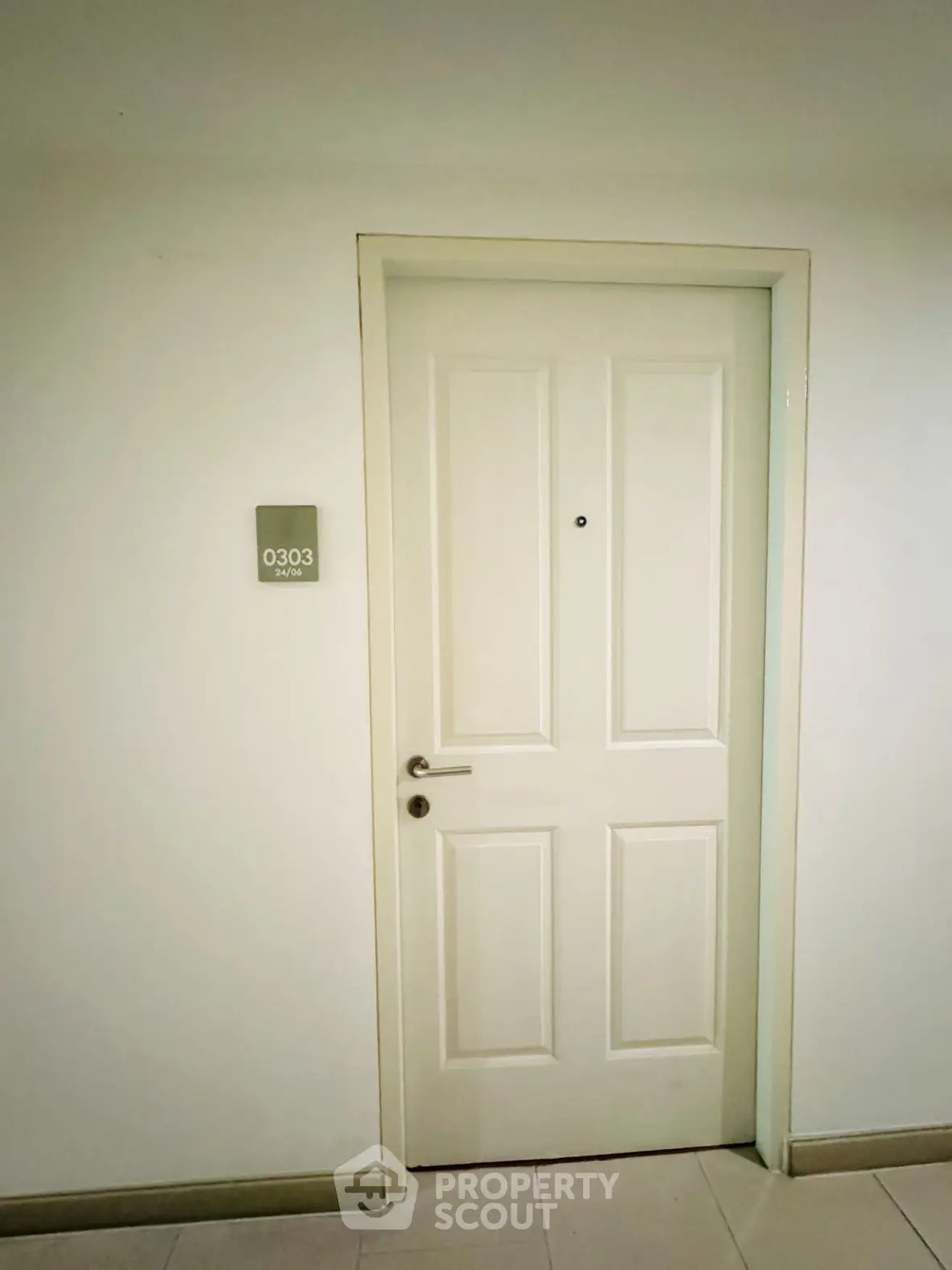 Modern apartment entrance with white door and room number 0303.