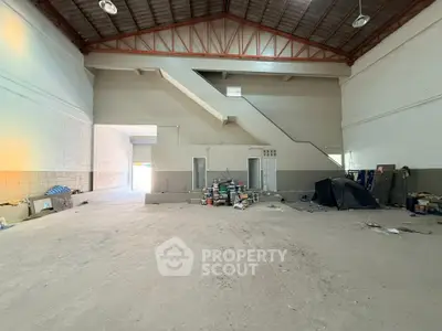 Spacious industrial warehouse interior with high ceilings and storage potential.