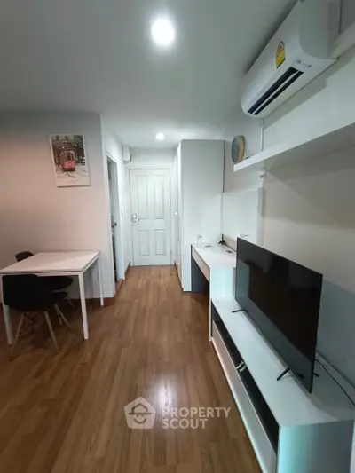 Modern living room with sleek furniture and wooden flooring