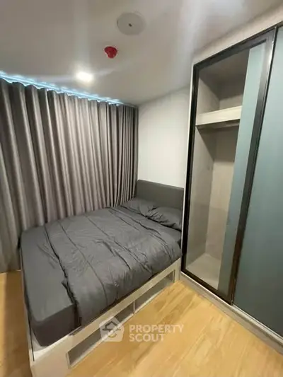Modern bedroom with sleek design and ample storage in a contemporary apartment.