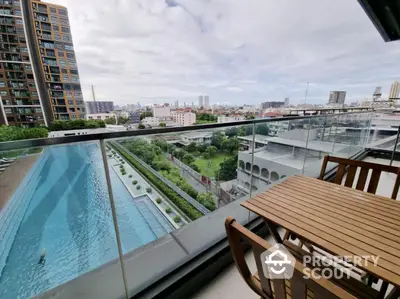 Luxurious balcony with stunning city view and pool access in modern high-rise apartment