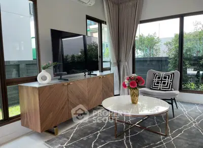 Stylish living room with modern decor, large windows, and elegant furniture.