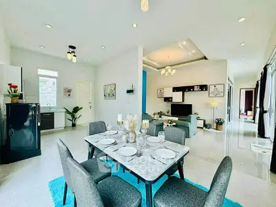 Spacious open-plan living and dining area with modern decor and natural light.