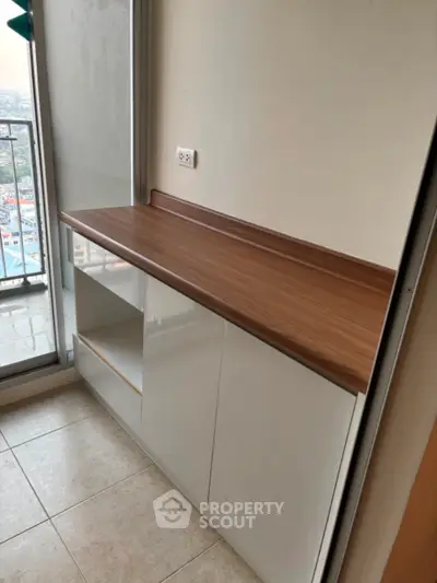 Modern balcony with built-in wooden countertop and city view