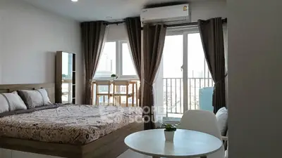 Modern bedroom with balcony view in urban apartment