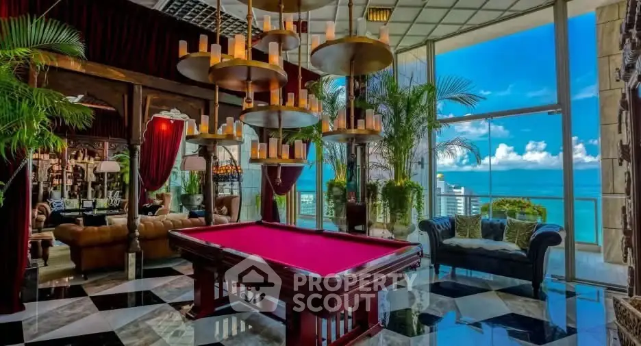Luxurious living room with pool table and stunning ocean view