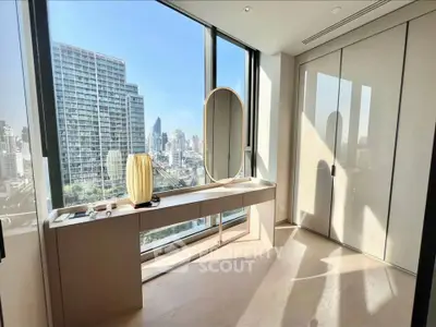 Modern room with large windows offering stunning city view and elegant decor