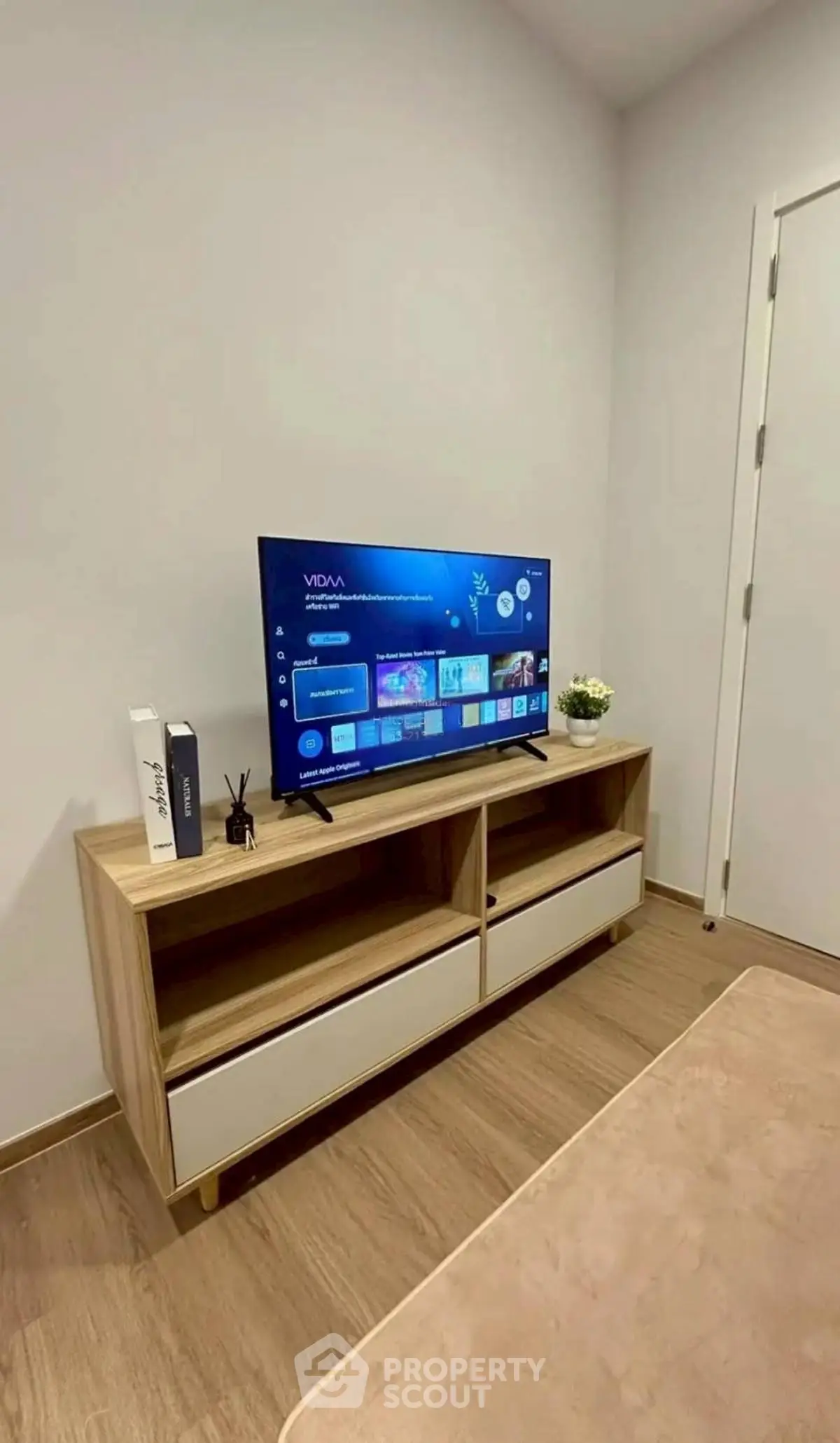 Modern living room with sleek TV setup and stylish wooden console.