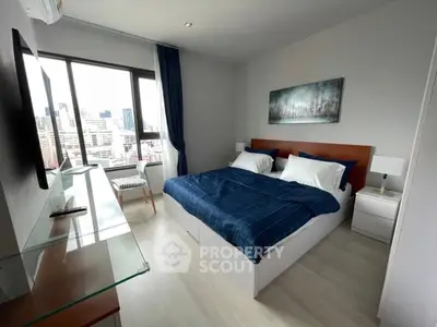Modern bedroom with city view, featuring a cozy bed and stylish decor.