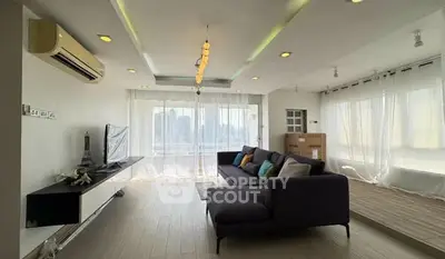 Spacious modern living room with large windows and stylish decor