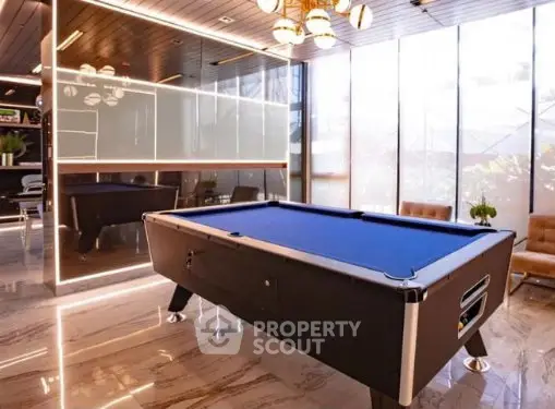 Luxurious indoor recreation area with modern pool table and stylish seating.