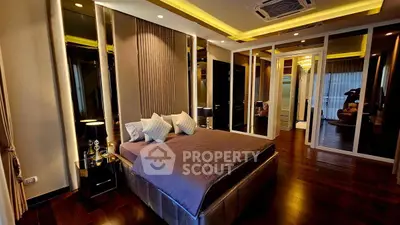 Luxurious modern bedroom with elegant lighting and plush furnishings.