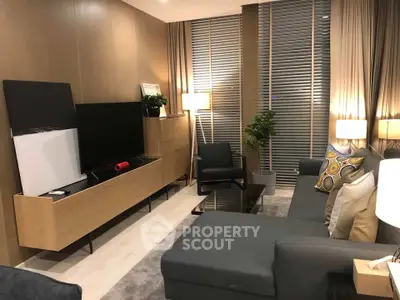 Modern living room with sleek furniture and ambient lighting, featuring a stylish entertainment center and cozy seating.