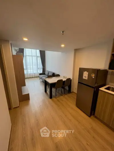 Modern living room with dining area and large window in stylish apartment